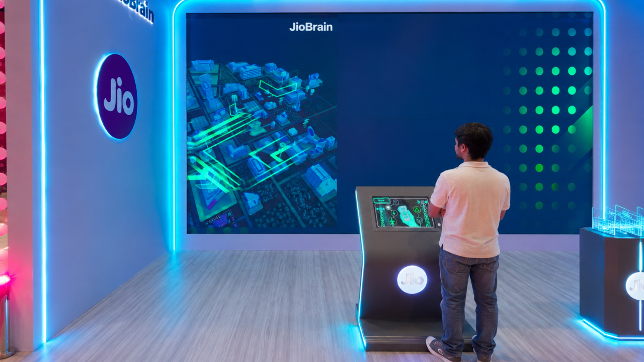 Visitor engages with a JioBrain wall display at an immersive tech booth